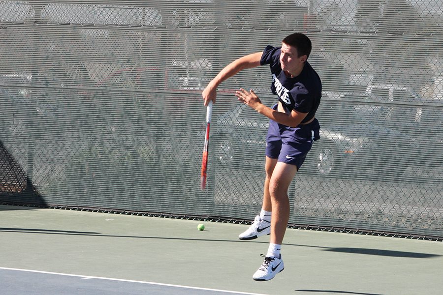 Sophomore Nikita Katsnelson follows through a swing during his singles match Friday, March 31 against Mesa Ariz. College. Katsnselson won his singles and doubles match. 