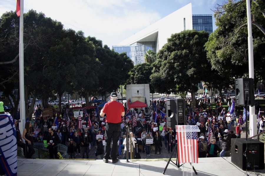 Political figures and priests touted conspiracy theories to the maskless crowd on Jan. 6 in front of Los Angeles city hall. They believe the presidential election was stolen by Democrats and China. 