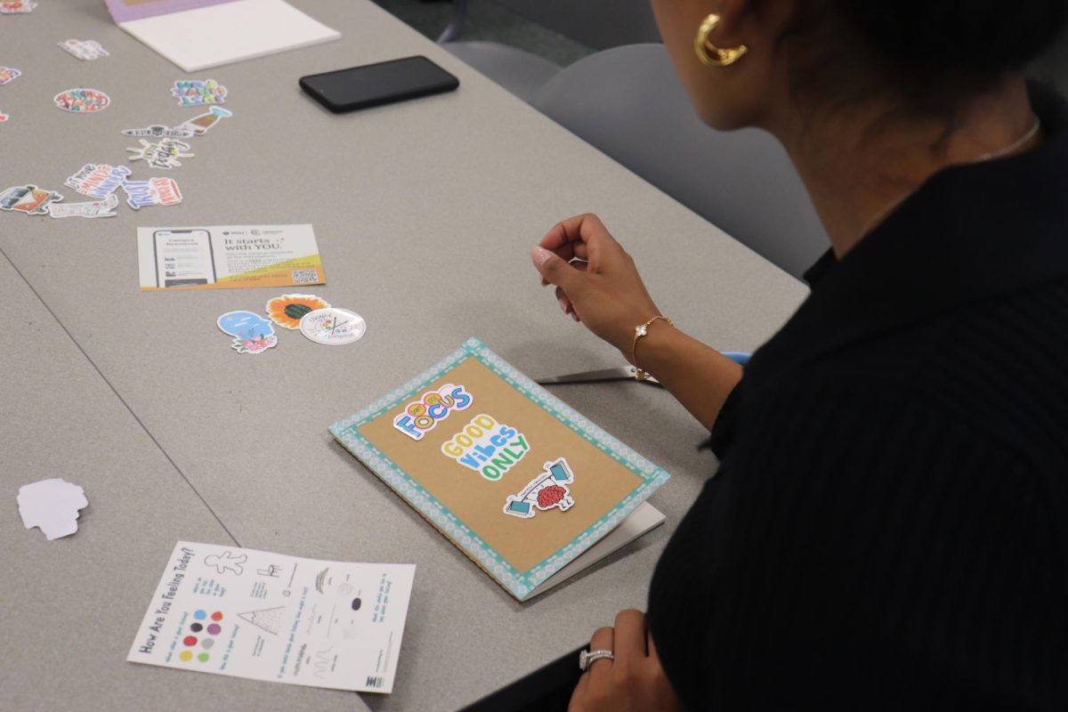 Cerritos College therapist, Damanpreet Rai, decorating her journal at the Journaling for Wellbeing workshop on Sept. 19. Photo credit: Isaac Cordon