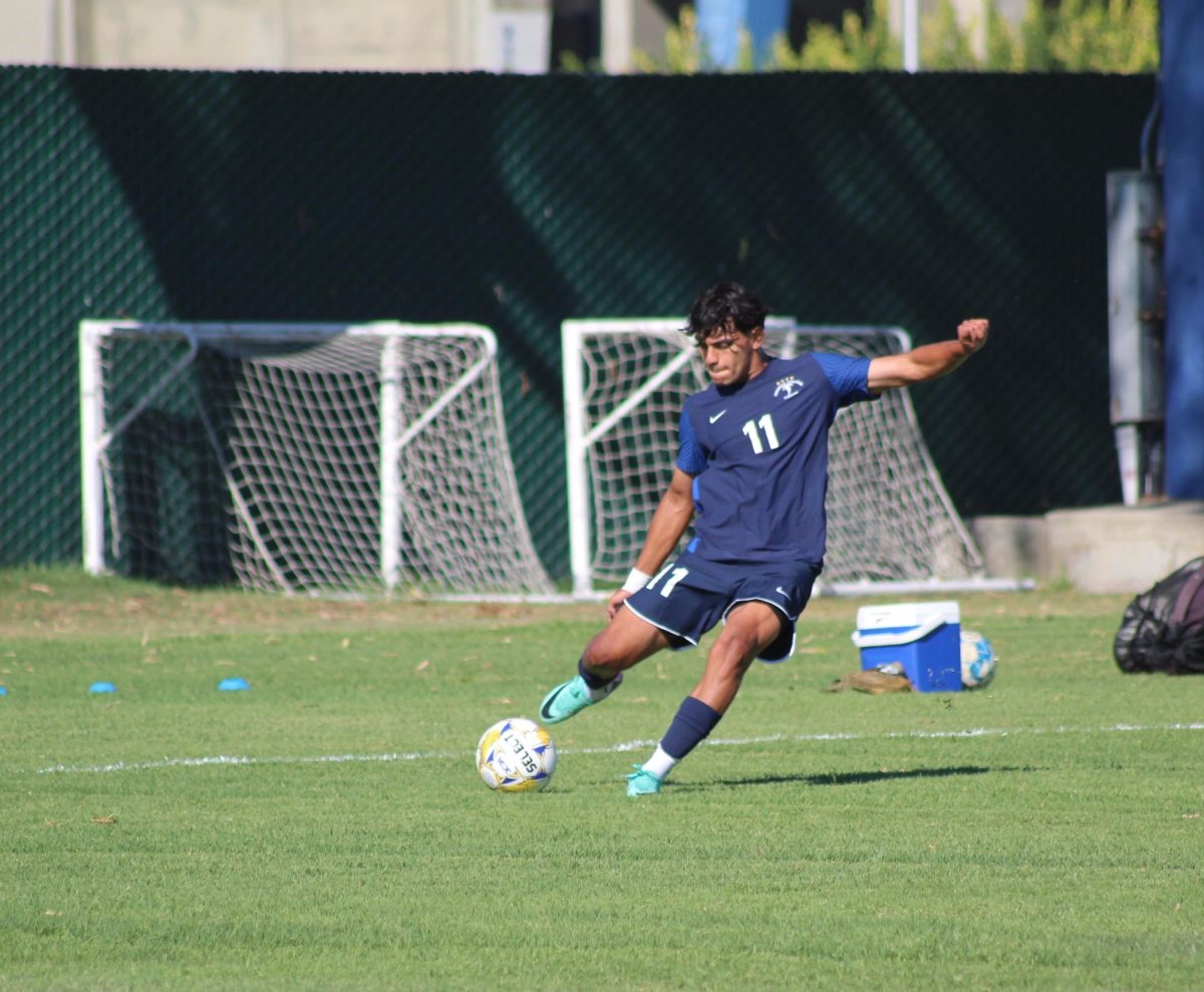 #11 Pedro Reyes prepares to place a freekick into the box 