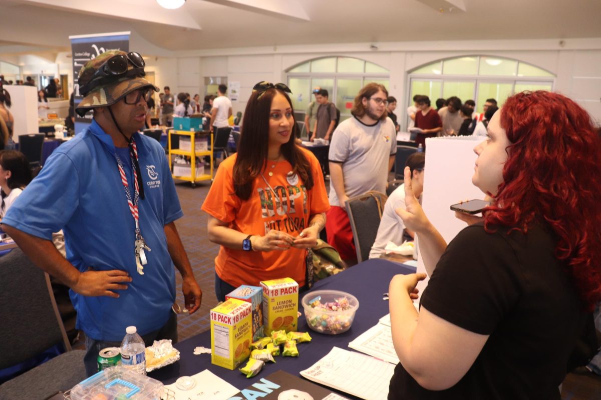 The president and vice president of the American Sign Language club conversing with a person at their booth during the fall 2024 Club Rush in the Cerritos College Student Center on Sept. 3. 