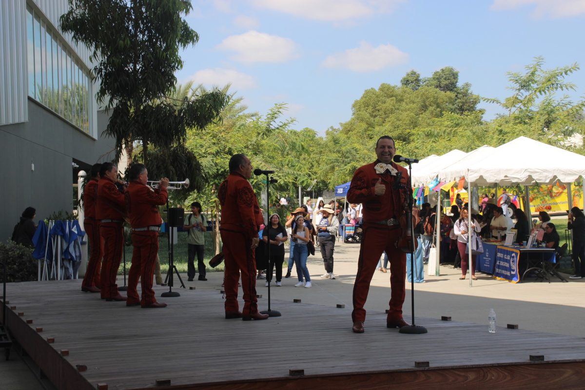 A mariachi ensemble playing music on the stage to the side of the Performing Arts Center for those attending the La Feria Latina event hosted by the Student Programming Board on Sept. 18. 