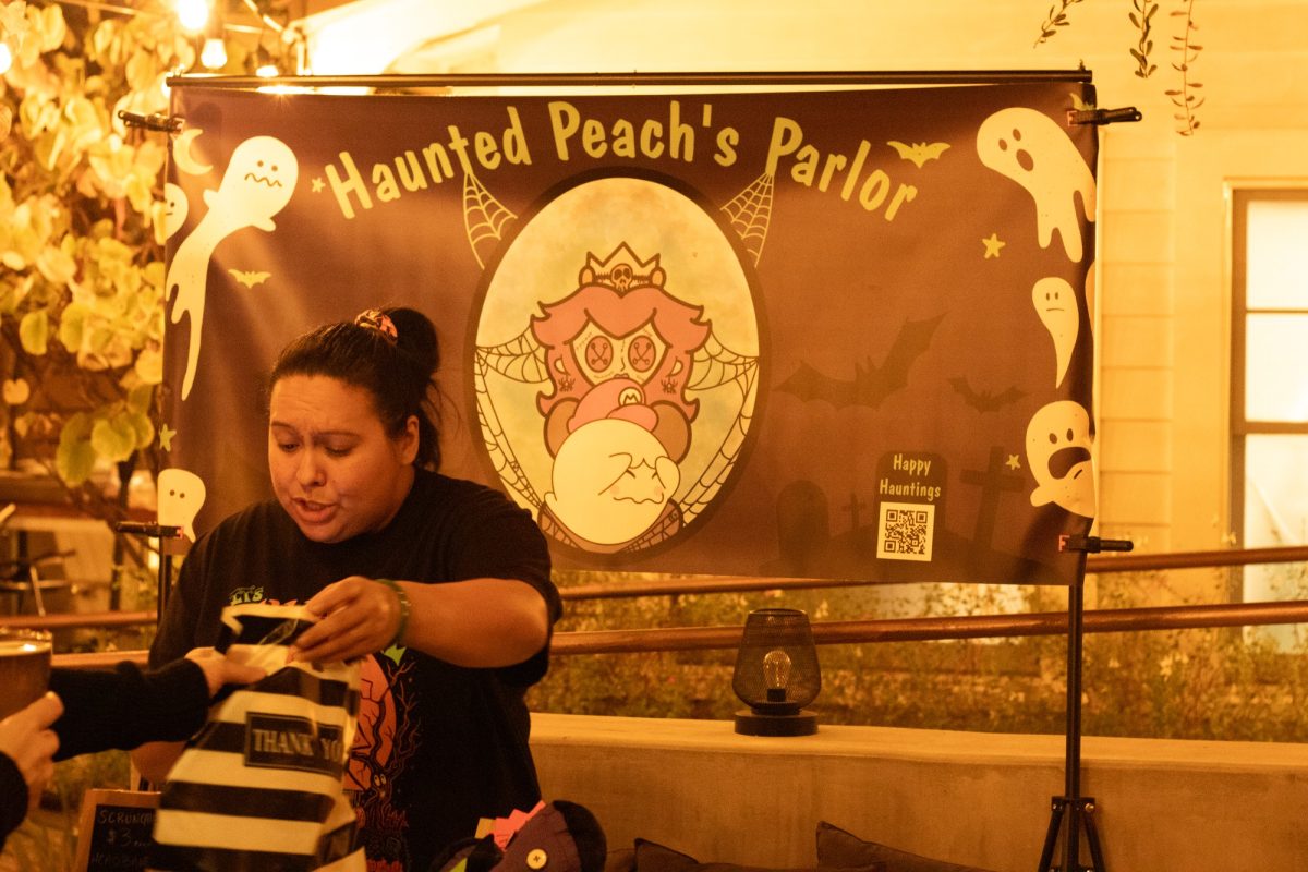 Haunted Peach's Parlor making a sale and handing the order to the customer. 