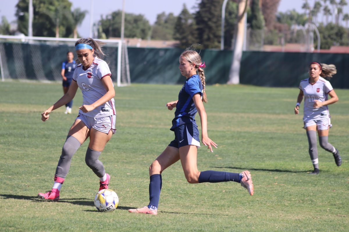 #18 Madi Jones kicking the ball in the box 