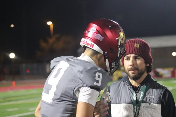 Downey High School football Offensive coordinator Justin Alegria talking to 4 star quarterback Oscar Rios after drive aganist the Mayfair Monsoons on November 1