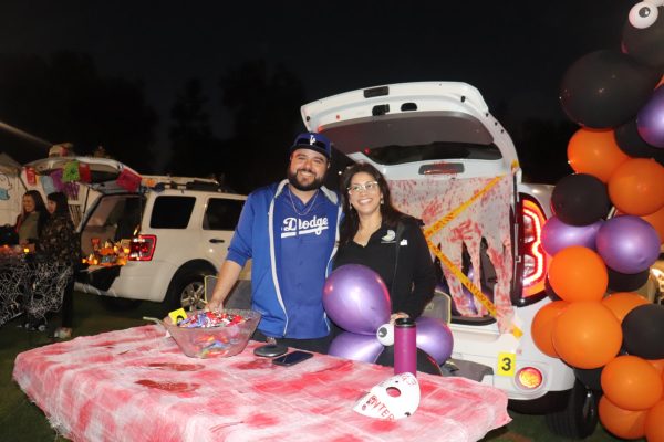 City clerk, Daisy Gomez, at the trunk or treat section distributing candies.