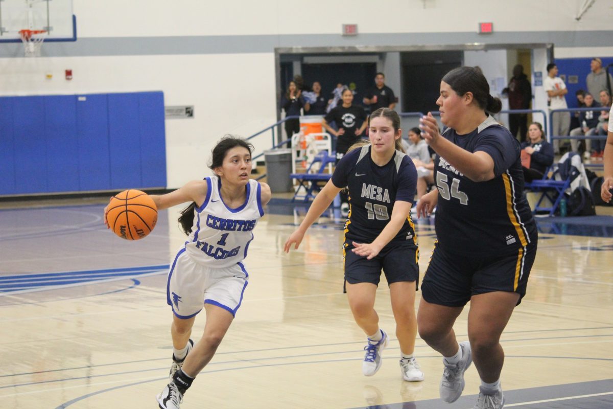 Salma Garcia (left) driving on San Diego Mesa players Christina Bowen (middle) and Alethze Marquez (right) during the Cerritos vs. San Diego Mesa women's basketball game on Nov. 6. 