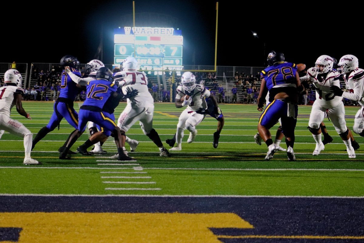 Senior running back/middle linebacker Bernardo Blanco rushing towards the end zone 