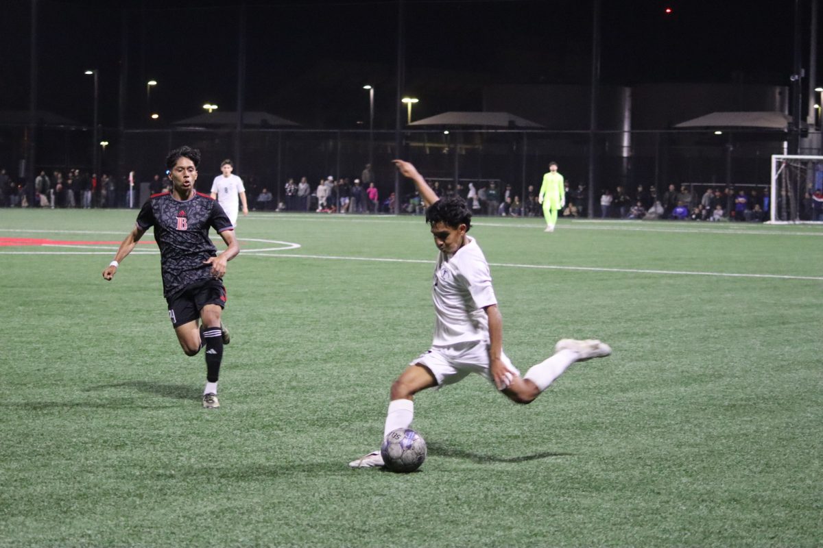 #17 Edgar Ausencio kicking the ball into the box. Photo credit: Duran Ventura