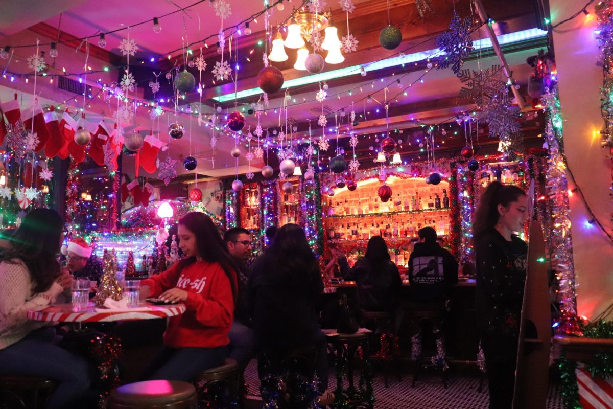 Customers sitting at tables and the bar at The Ordinaire in Long Beach.