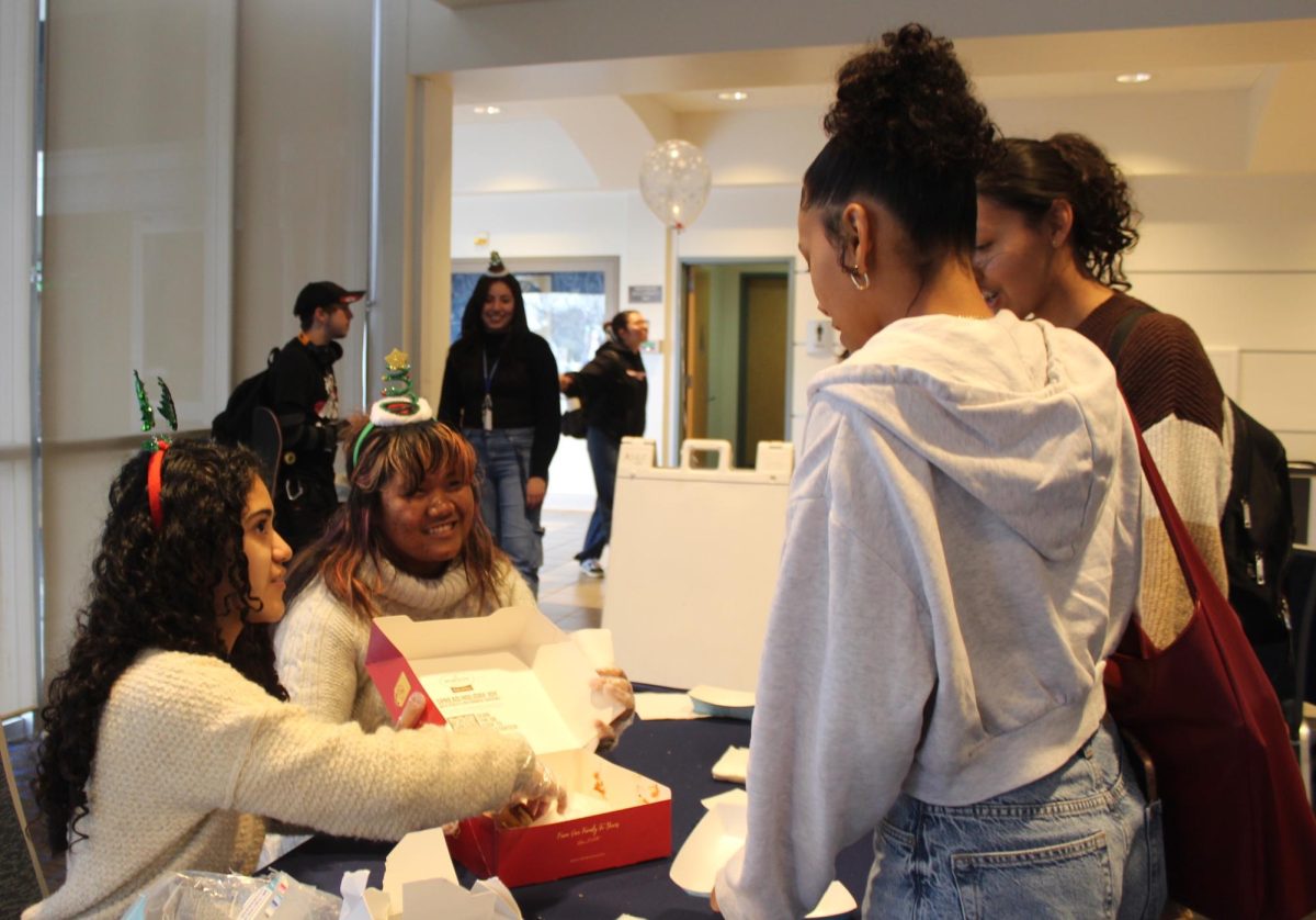 Student programming members, Michaela Cuevas and Jasmine Reyes giving out pastries to students during the Winter Wellness event on Dec. 11, 2024. Photo credit: Isaac Cordon