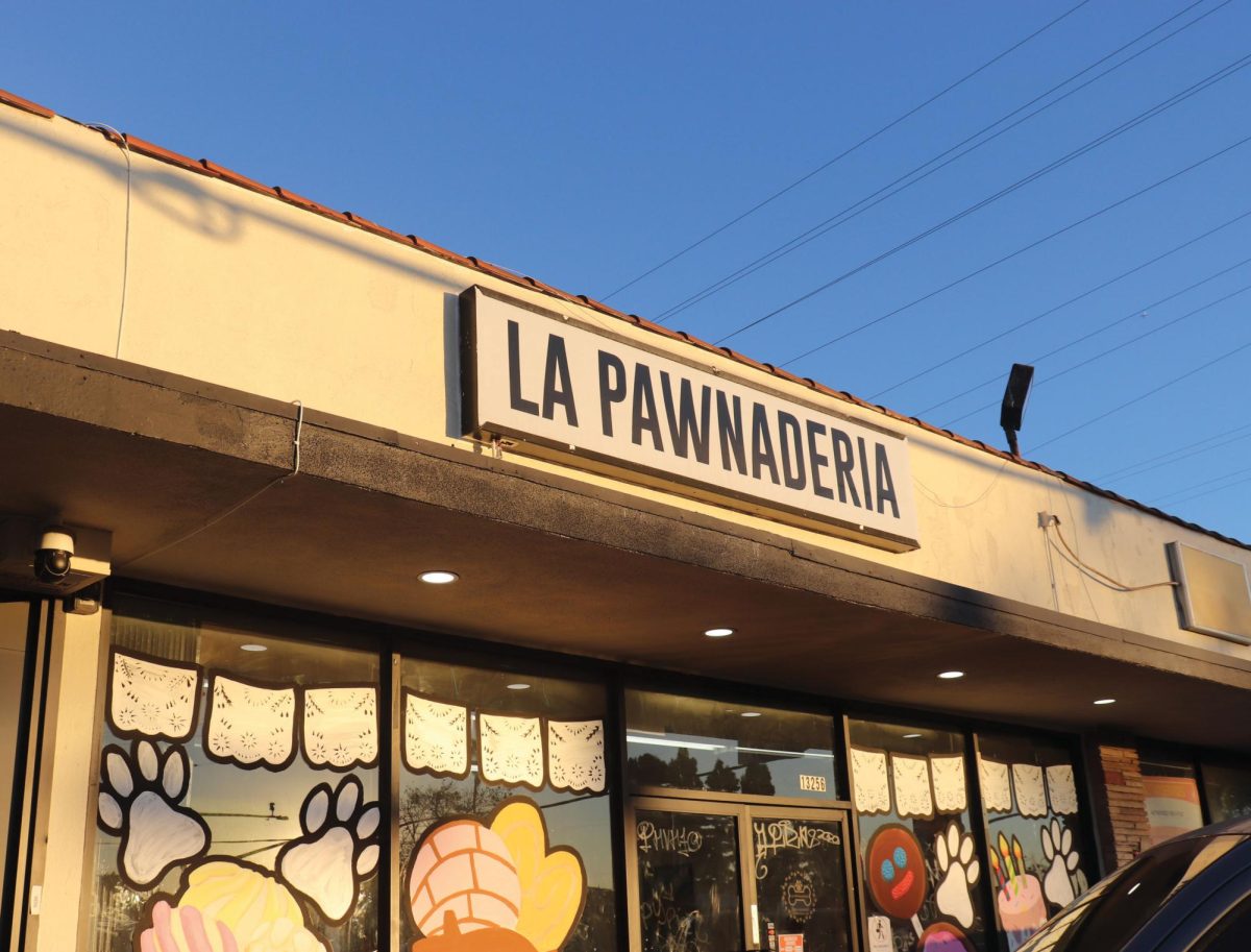 The outside view of the bakery with art drawn on the windows.