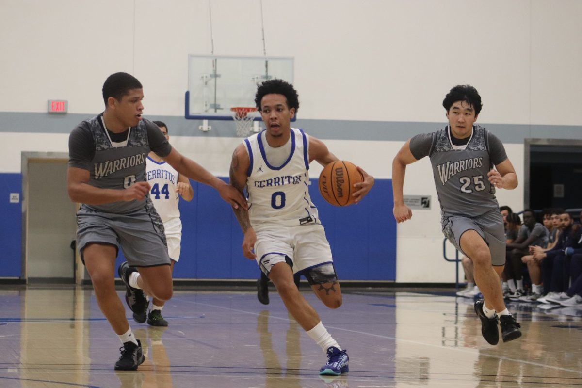 Elijah Andrews sprinting down court on a fast break with Kai Johnson and Joshua Eguchi from El Camino defending on Feb. 14, 2025