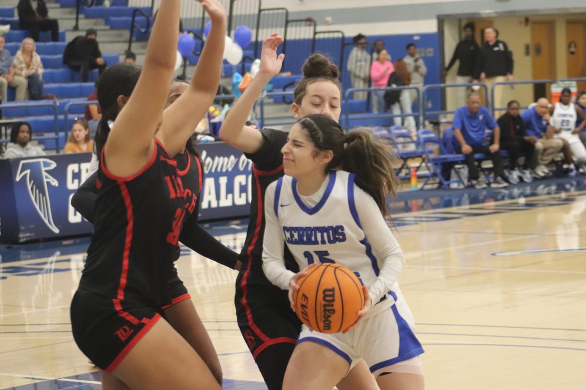 Cerritos College guard, Jayden Estrada, driving to the basket as Long Beach City College players defend her on Feb. 19, 2025.