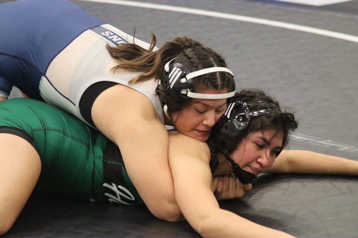 Ximena Romero attempting to put Bella Arredondo in a chokehold during the Cerritos Open women's wrestling event on Jan. 25, 2025.