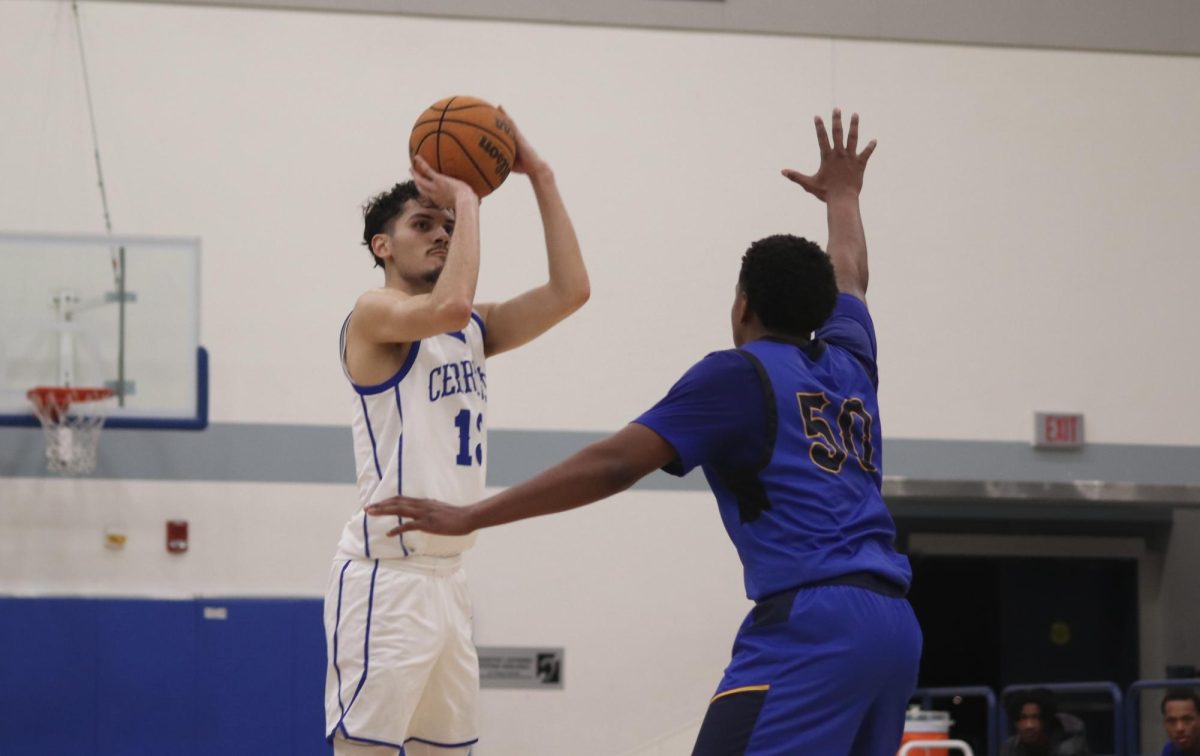 Falcons forward, Andrew Mata shooting a three point attempt with Cougars forward, Chase McDuffie defending the shot during the Cerritos College vs. Los Angeles Southwest men's basketball on Feb. 6, 2025.