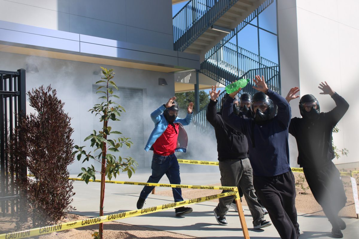 Actors portraying victims running out the Health Science building at Cerritos College for the active shooter drill on Feb. 26, 2025.