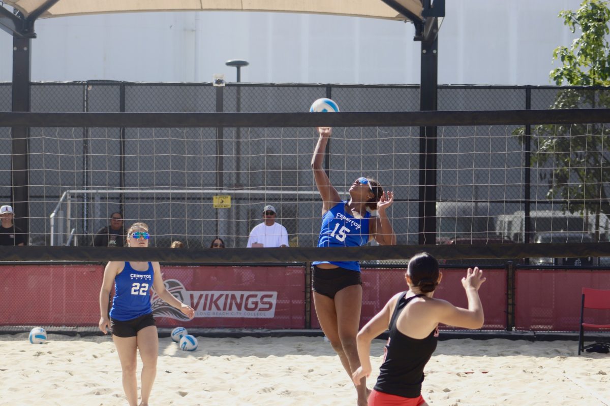 Aiyana Sierra spiking the ball with Abby Gutierrez behind her in matchup against the LBCC Vikings on Feb. 28, 2025.