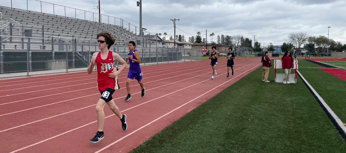 Downey High School runner leading the way on the final lap of the Boy's Varsity 1600 meter race on March 1, 2025.